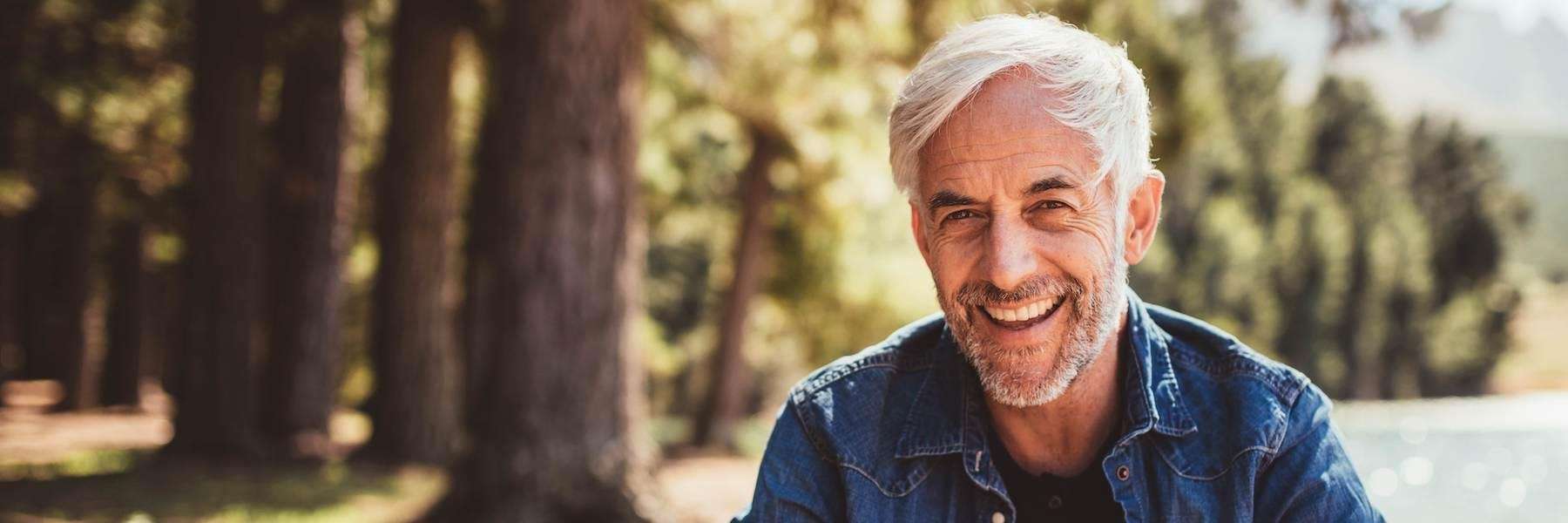 An elderly man with a big smile on his face