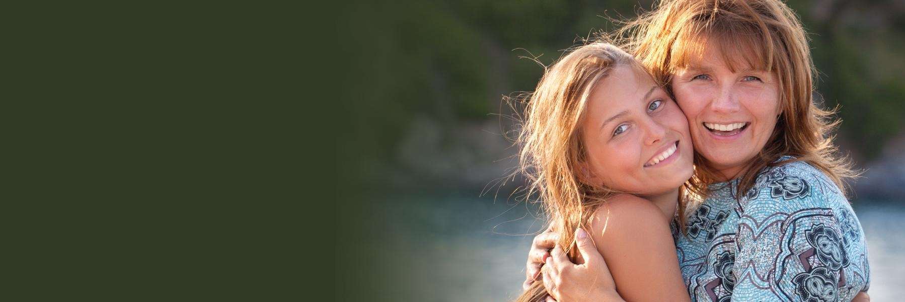 mother and daughter smile after dental implants in Seymour