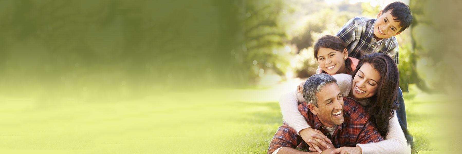 family in the park smiling after visiting tn family dentist
